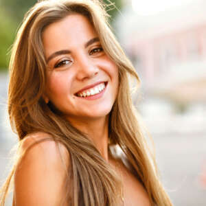 elegant-young-magnificent-woman-with-big-brown-eyes-and-amazing-smile Elegant young magnificent woman with big brown eyes and amazing smile, posing on the street, stylish clothes and accessories, sunny soft summer light, natural beauty.